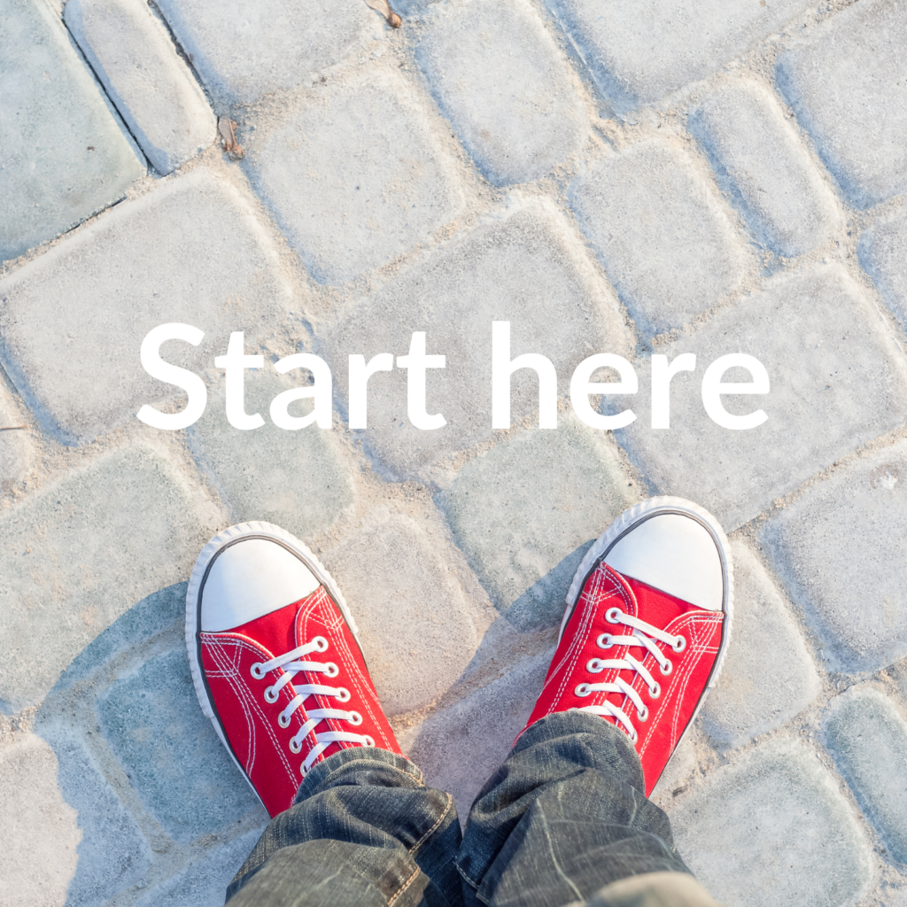Start here A pair of red shoes on a cobblestone pavement